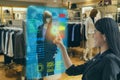 Iot smart retail futuristic technology concept, happy girl try to use smart display with virtual or augmented reality in the shop