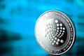 Iota coin cryptocurrency on the blue background