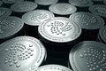 IOTA coins in blurry closeup. New cryptocurrency and modern banking concept.