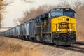 Iowa Interstate locomotive pulls freight covered hoppers