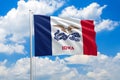 Iowa national flag waving in the wind on clouds sky. High quality fabric. International relations concept Royalty Free Stock Photo