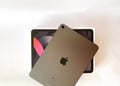 The iPad Air 2020 tablet in black color lies on a branded box on a white isolated background. Back side view of the tablet Royalty Free Stock Photo