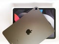 The iPad Air 2020 tablet in black color lies on a branded box on a white isolated background. Back side view of the tablet Royalty Free Stock Photo