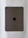 The iPad Air 2020 tablet in black color lies on a branded box on a white isolated background. Back side view of the tablet Royalty Free Stock Photo