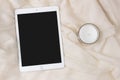 IPad Apple tablet with a candle. Elegant and cozy feminine background, concept for advertisement