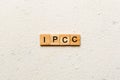 IPCC word written on wood block. abbreviation Intergovernmental Panel on Climate Change text on cement table for your Royalty Free Stock Photo