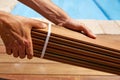 Ipe deck installation carpenter hands holding wood Royalty Free Stock Photo