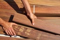 Ipe deck installation carpenter hands holding wood Royalty Free Stock Photo