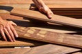 Ipe deck installation carpenter hands holding wood Royalty Free Stock Photo