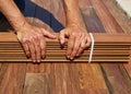 Ipe deck installation carpenter hands holding wood Royalty Free Stock Photo