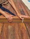 Ipe deck installation carpenter hands holding wood Royalty Free Stock Photo