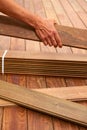 Ipe deck installation carpenter hands holding wood Royalty Free Stock Photo