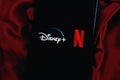 IPhone with the DISNEY PLUS and NETFLIX logo