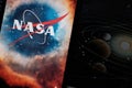 Iphone with NASA logo background planets. NASA is the US government agency