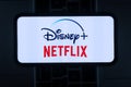 Iphone with the Netflix logo, Inc. and Disney Plus