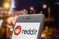 An iPhone Plus with a Reddit logo on the screen Royalty Free Stock Photo