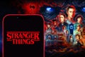 Iphone 13 pro with the Stranger Things logo Things is an American web series of suspense and science. Royalty Free Stock Photo