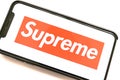 IPhone with Supreme logo on the screen.