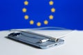 iPhone with usb x to Lightning cable with eu flag in The backgroudn