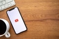 IPhone X with app YouTube Google and background wooden desk