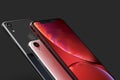 3 iPhone XR Red, silver and Space Grey smart phones on black