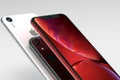 3 iPhone XR Red, silver and Space Grey smart phones on white