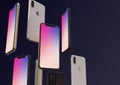 IPhone XS Gold, Silver and Space Grey smartphones, floating in air, colorful screen