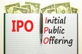 IPO initial public offering symbol. Concept words IPO initial public offering on beautiful white note. Beautiful dollar bills