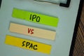 IPO Vs SPAC write on sticky notes isolated on Wooden Table