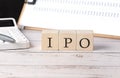 IPO word on a wooden block with clipboard and calculator Royalty Free Stock Photo