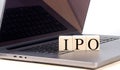 IPO word on wooden block on laptop , business concept Royalty Free Stock Photo