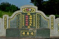 Large Chinese grave and tombstone with golden Mandarin writing at cemetery Ipoh Malaysia