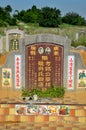 Grave of Chinese married couple together with ornate tombstone at cemetery graveyard Ipoh Malaysia