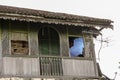 Wooden galleries and balconies with broken windows of an old vintage house in the abandoned Royalty Free Stock Photo