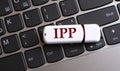 IPP - the word on a white flash drive, lying on a black laptop keyboard Royalty Free Stock Photo