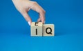 IQ or EQ symbol. Businessman hand turns cube with words IQ, intelligence quotient to EQ, emotional quotient. Beautiful blue Royalty Free Stock Photo