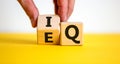 IQ or EQ symbol. Psychologist flips a cube, changes words IQ, intelligence quotient to EQ, emotional quotient. Beautiful white Royalty Free Stock Photo