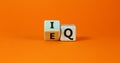 IQ or EQ symbol. Turned a cube, changed words IQ, intelligence quotient to EQ, emotional quotient. Beautiful orange background. Royalty Free Stock Photo