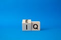 IQ or EQ symbol. Turned cube with words IQ, intelligence quotient and EQ, emotional quotient. Beautiful blue background. Emotional Royalty Free Stock Photo