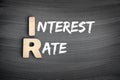IR - Interest Rate acronym, business concept on blackboard