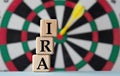 IRA - acronym on wooden cubes on dartboard background