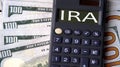 IRA - acronym written on a calculator on the background of banknotes Royalty Free Stock Photo