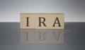 IRA concept, wooden word block on the grey background