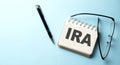 IRA text written on a notepad on the blue background Royalty Free Stock Photo