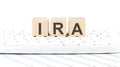 IRA -word wooden block on keyboard background witn chart