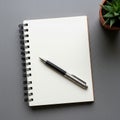 Iral-bound notebook with blank white pages and a black and silver pen resting Royalty Free Stock Photo