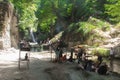 Sari, Iran - 18 July 2017: Waterfall at north of Iran, with iranian taking a swim with clothes and preparing barbacoe and iranian Royalty Free Stock Photo