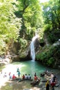 Sari, Iran - 18 July 2017: Waterfall at north of Iran, with iranian taking a swim with clothes and preparing barbacoe and iranian Royalty Free Stock Photo