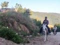 Mazandaran, Iran - 19 July 2017: his donkey carrying a iranian guy in the mountain of north of Iran