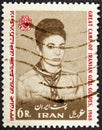 IRAN - CIRCA 1968: Postage stamp printed in Iran shows Iranian Empress Farah in girl scout uniform, emblem, 1st Iranian